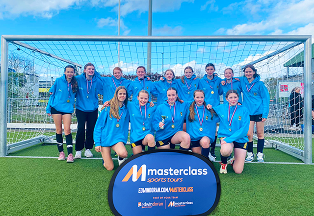 A Masterclass group posing in front on a goal in Valkenburg