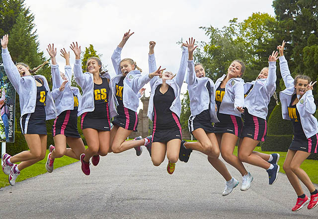 Netball girls jumping with joy outside Condover Hall