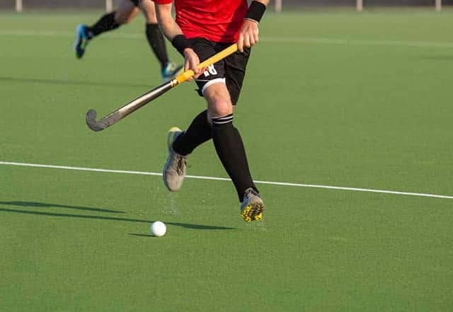 Field hockey player on artificial grass play field